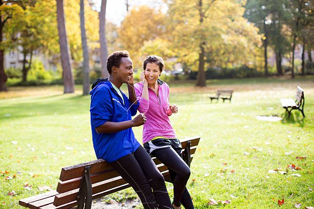 A couple exercising together in a park